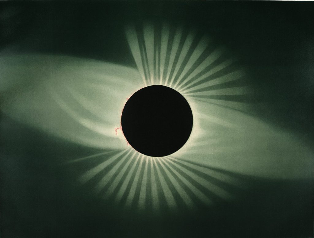 illustration of a black circle with rays shining out of its centre to depict a total eclipse of the sun